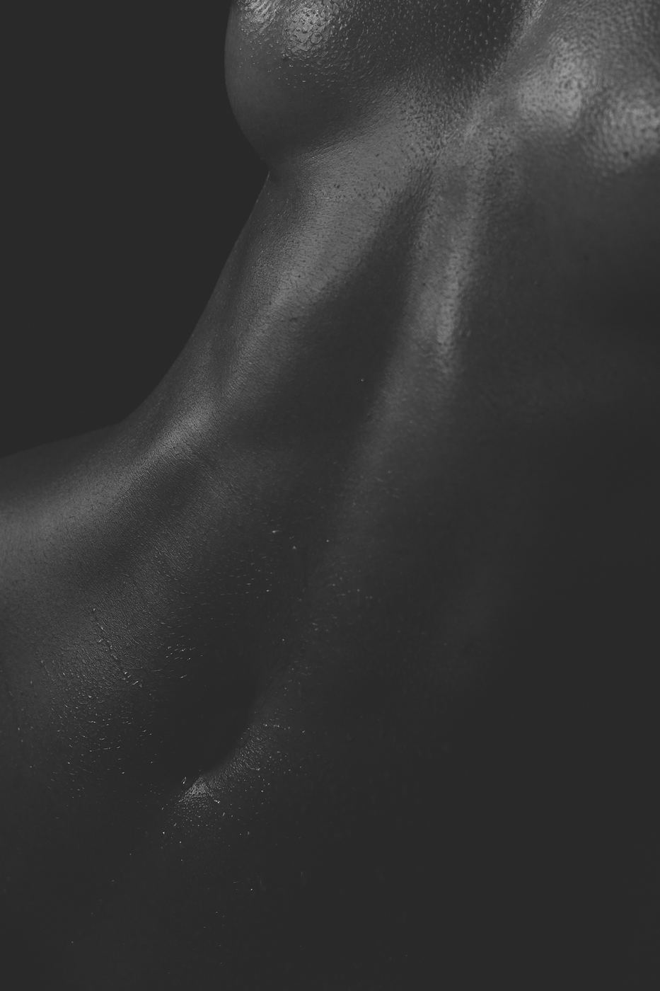 Low-key black and white body detail with dramatic shadow, fine art nude by Armand Sanchez