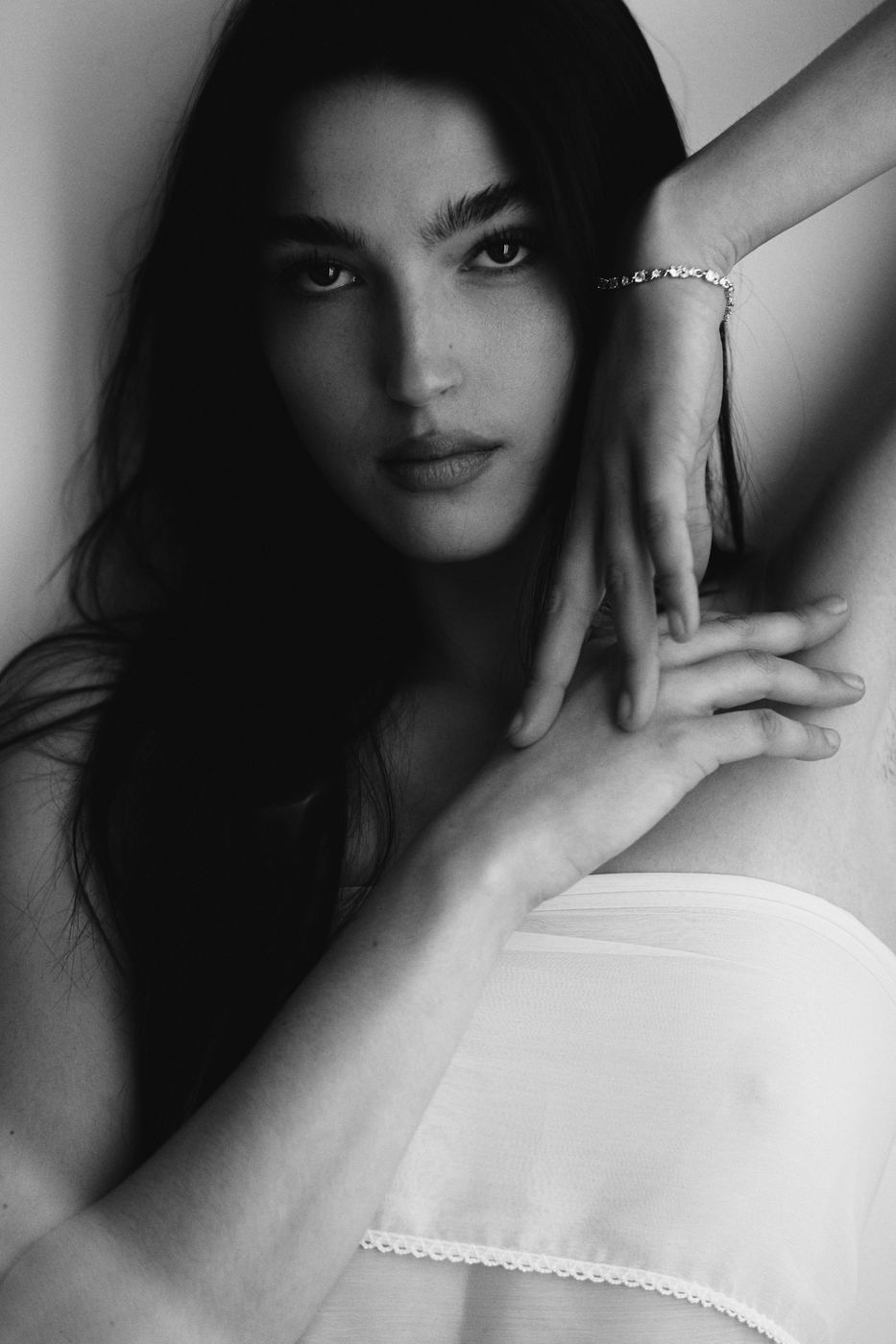 Black and white beauty portrait of a woman in a white top, photographed by Armand Sanchez in Salt Lake City